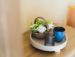 Woven basket with white flowers beside mug and glass at High Brake House, Ribble Valley