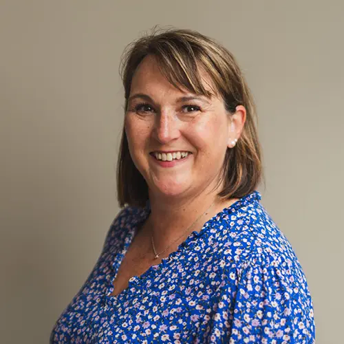 Smiling woman in blue floral blouse at High Brake House care home, Ribble Valley, Lancashire