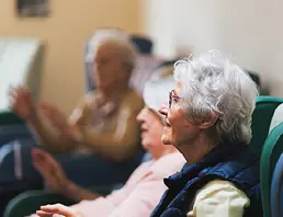 Elderly women smiling together in dementia care setting at Lancashire care home