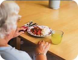 Elderly resident enjoying a meal at High Brake House care home, Ribble Valley, Lancashire