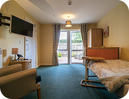 Well-lit bedroom with patio view at High Brake House care home, Ribble Valley, Lancashire