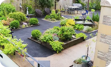 Landscaped care home garden in Clitheroe with pathways, raised beds and seating