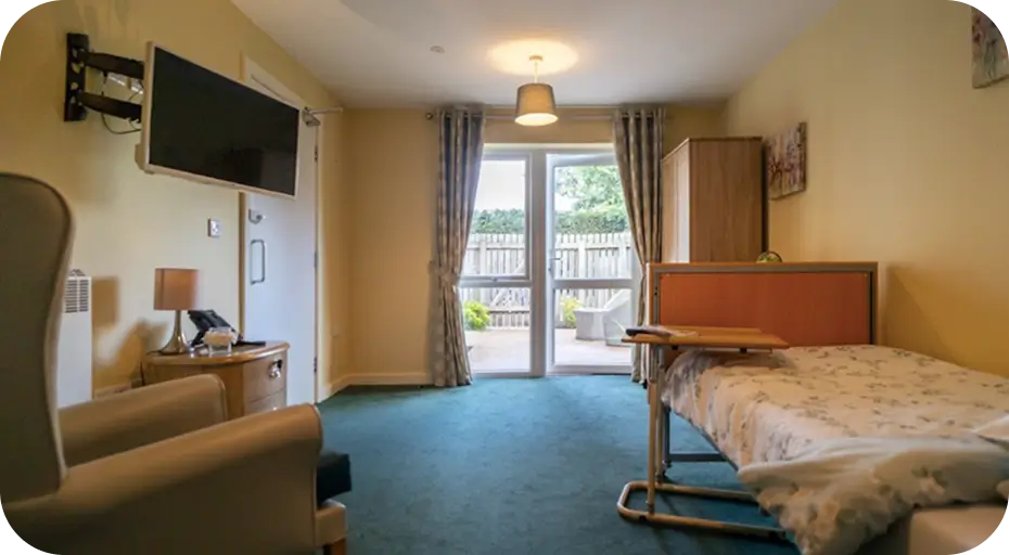Cosy care home bedroom in Clitheroe with patio doors and garden view