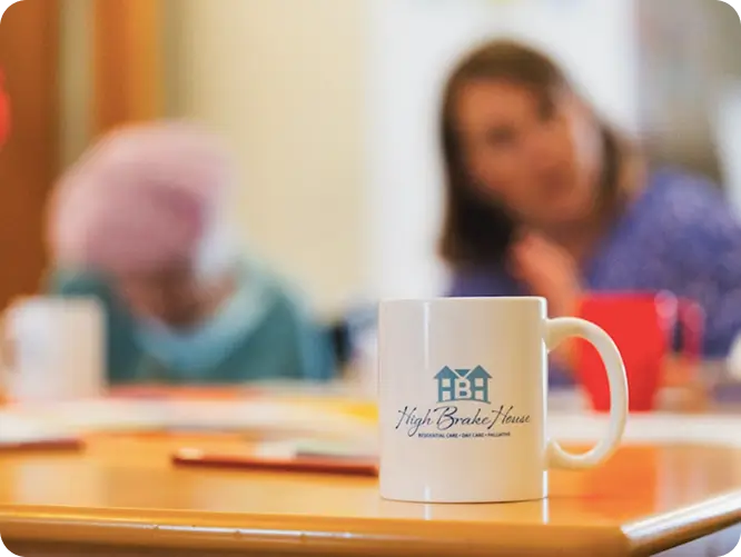 High Brake House mug on a table, showing daily life in a Lancashire care home